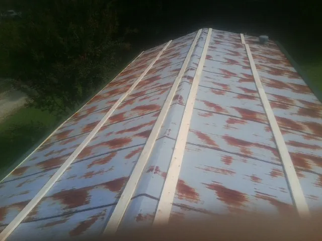Rusted metal roof panels with new wood purlins before replacement — Storm Damage Roof Repair in Timberville by Roofing Brothers